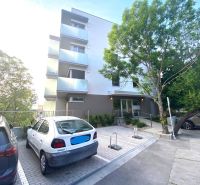 Exterior of the building on Drotárska cesta, Bratislava - Staré Mesto, with a parking lot.