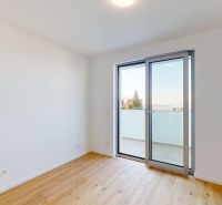 An empty room with a wooden floor decor and balcony doors in offices.