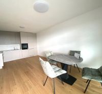 Offices with wood-patterned flooring, a kitchenette, and a dining table.