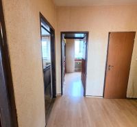 A hallway with walls in a 3-room apartment and a floor with a wooden decor.