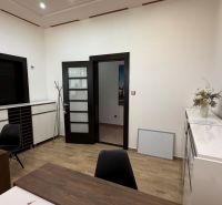 Interior of an office with wooden decor, modern furniture, and decorations on the desk.