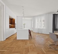 A kitchen in a 4-room apartment with an island and a floor with a wood decor.