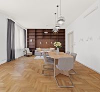 The meeting of elegance and functionality in the dining room of a 4-room apartment with a wooden decor floor.