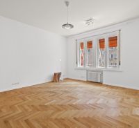 A bright room with a tree chair, large windows, and a wood-patterned floor in a 4-room apartment.