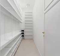 White built-in wardrobe with shelves and storage space in a 4-room apartment.