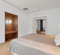 Bedroom with a wardrobe, bed, built-in lighting, and floor with wood decor in a 4-room apartment.
