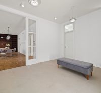 Entrance hall of a 4-room apartment with a bench and a wooden decor floor.