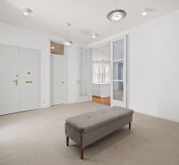 A bright hallway with a bench leads to a 4-room apartment with glass doors.