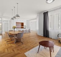 A four-room apartment space with a wooden decor floor and a dining table.