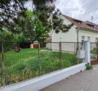 A family house on K Dolnej stanici in Trenčín, enclosed by a fence, with a grassy yard.