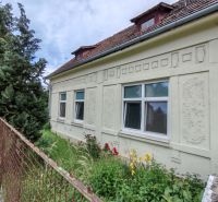 A family house on K Dolnej stanici Street in Trenčín, with a garden and fencing.