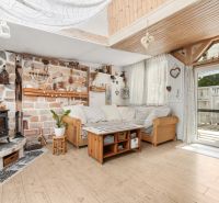 Living room in a family house with a fireplace and a wooden decor floor.