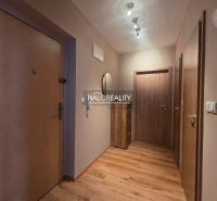 Entrance hallway in a 2-room apartment with a wooden decor floor and wooden doors.