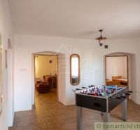 Interior of a family house with a foosball table and a wooden decor floor.
