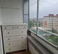 Balcony of a 3-room apartment in Bratislava on Holíčska Street with a wooden decor floor.