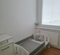 Children's room in a 3-room apartment with a bed and a wooden decor floor.