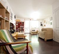 Living room in a 3-room apartment with a wooden decor floor and comfortable seating.