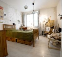 Bedroom in a 3-room apartment with space for creative work and a floor with a wooden decor.