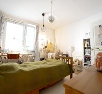 Bedroom in a 3-room apartment with wooden decor furniture, a desk, and decorations.