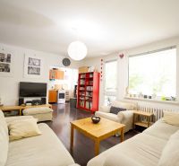 Living room of a 3-room apartment with comfortable sofas and a wooden decor floor.
