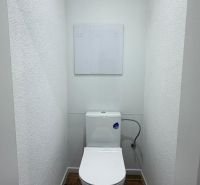 WC with a wooden decor floor in a 3-room apartment.