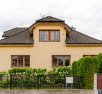 A family house on Kpt. Jaroša Street in Trenčín with a dark roof and a green fence.