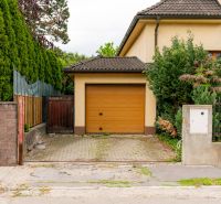 Entrance to the garage of a family house on Kpt. Jaroš Street in Trenčín with a landscaped garden.