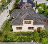 A family house on Kpt. Jaroš Street in Trenčín with a well-maintained garden and a paved walkway.