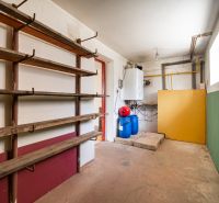 Boiler room in a family house with shelves and blue containers.