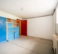 A room in a family house with a blue cabinet, white walls, and a white ceiling.