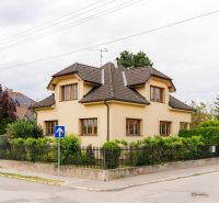 A family house in Trenčín on Kpt. Jaroša Street surrounded by greenery and a fence.