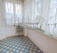 Sunny veranda with checkered tiles and a radiator in a family house.