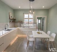 A kitchen in a family house with a dining table and open shelves.