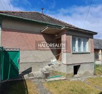 A family house in Veľké Kršteňany with a hallway and staircase, surrounded by a green fence.