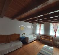 Interior with wood-patterned flooring, simple furniture, and a wooden ceiling.
