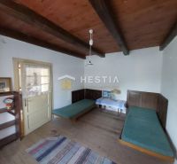 A room with a wooden ceiling, two beds, and a shelf, Land - living.