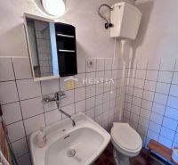 Bathroom with sink, mirror, and toilet. Suitable for residential plots.
