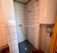 Bathroom with white tiles and a shower, offered on Residential Land.
