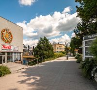Popradská Street in Stará Ľubovňa with buildings and shops, an ideal walk through a 3-room apartment.
