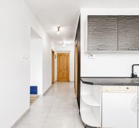 Kitchen in a 2-room apartment with wooden doors and white walls.
