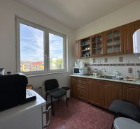 Office kitchen equipment with a view, cabinets, and appliances.