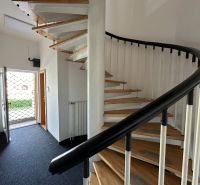 A spiral staircase with a wooden floor decor in offices.