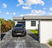 The exterior of a family house on Levanduľová Street in Miloslavov with a black car in the driveway.