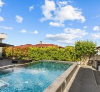 A swimming pool at a family house on Levanduľová Street in Miloslavov, surrounded by greenery.