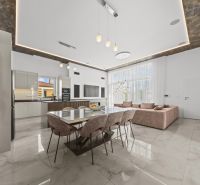 A space in a family house with a dining table and kitchen, wooden decor flooring.