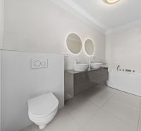 A bathroom with two sinks and a freestanding bathtub in a family house.