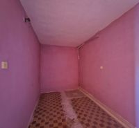 Pink room with tiled floor in a cottage.