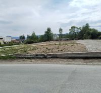 Commercial land in Martin with visible industrial surroundings and an access road.