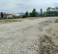 Land - commercial in Martin with a rocky surface and proximity to an industrial building.