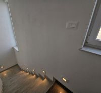 A staircase with integrated lighting and a window in a family house.